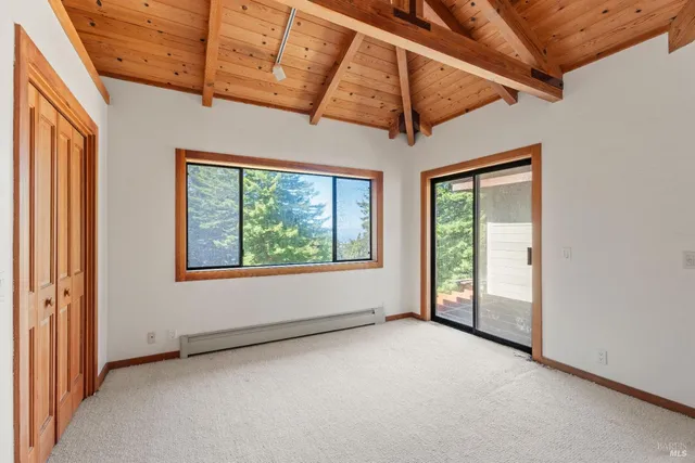 a bathroom with a granite countertop sink a toilet a mirror and shower