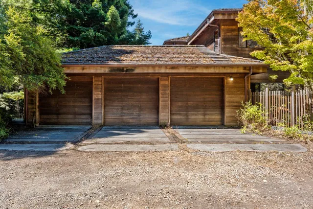 a backyard of a house with barbeque oven table and chairs