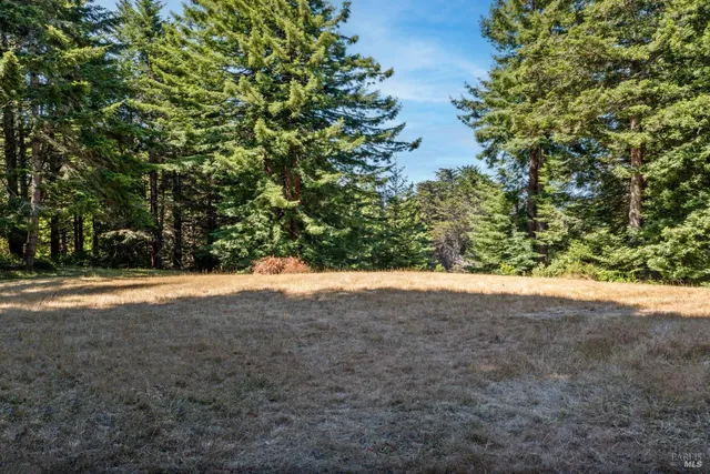 a view of a patio with table and chairs with wooden floor and fence