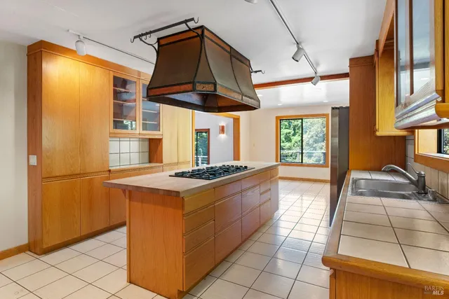 a kitchen with stainless steel appliances granite countertop a stove a refrigerator and a cabinets