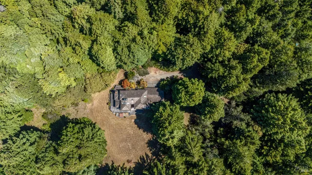 an aerial view of residential houses with outdoor space and river