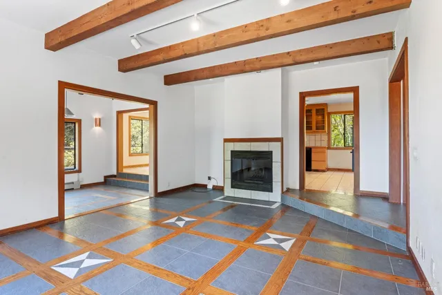 a view of a livingroom with a fireplace and window