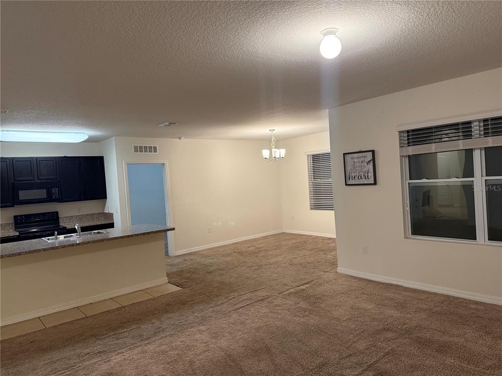1895 Hickory Bluff Road Kissimmee, FL 34744 - Photo 4 of 17 a view of a livingroom with a flat screen tv