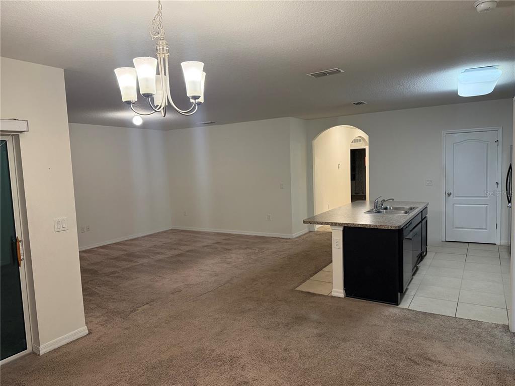 1895 Hickory Bluff Road Kissimmee, FL 34744 - Photo 5 of 17 a kitchen with a sink and chandelier