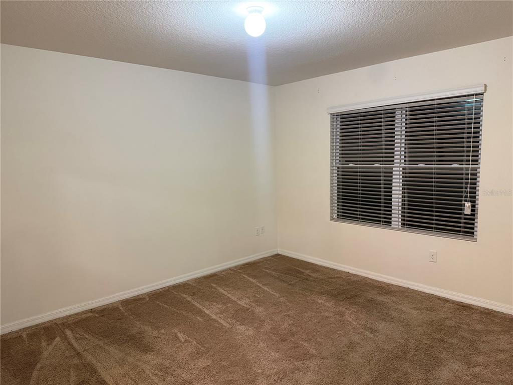 1895 Hickory Bluff Road Kissimmee, FL 34744 - Photo 6 of 17 a view of an empty room with a window