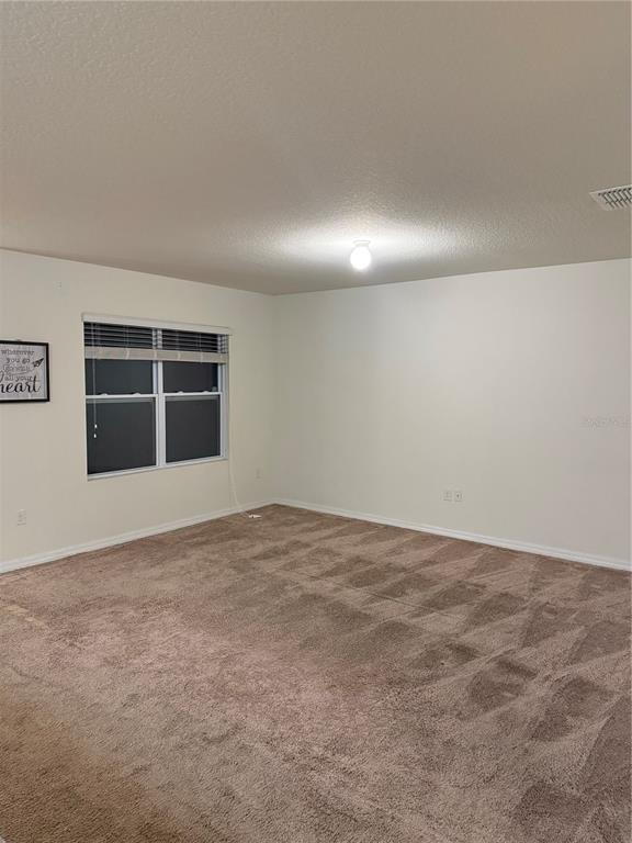 1895 Hickory Bluff Road Kissimmee, FL 34744 - Photo 8 of 17 a view of an empty room with a window