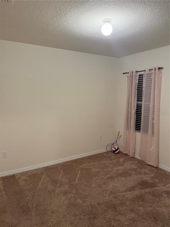1895 Hickory Bluff Road Kissimmee, FL 34744 - Photo 9 of 17 an empty room with windows