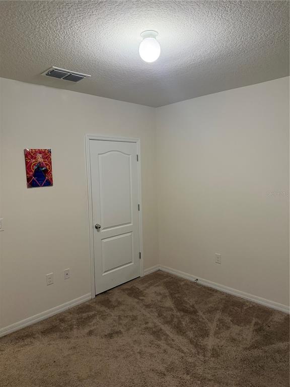 1895 Hickory Bluff Road Kissimmee, FL 34744 - Photo 10 of 17 an empty room with a workbench