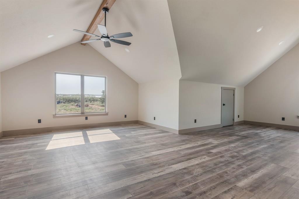 233 Jayden Lane Loving, TX 76460 - Photo 25 of 40 wooden floor in an empty room with a window