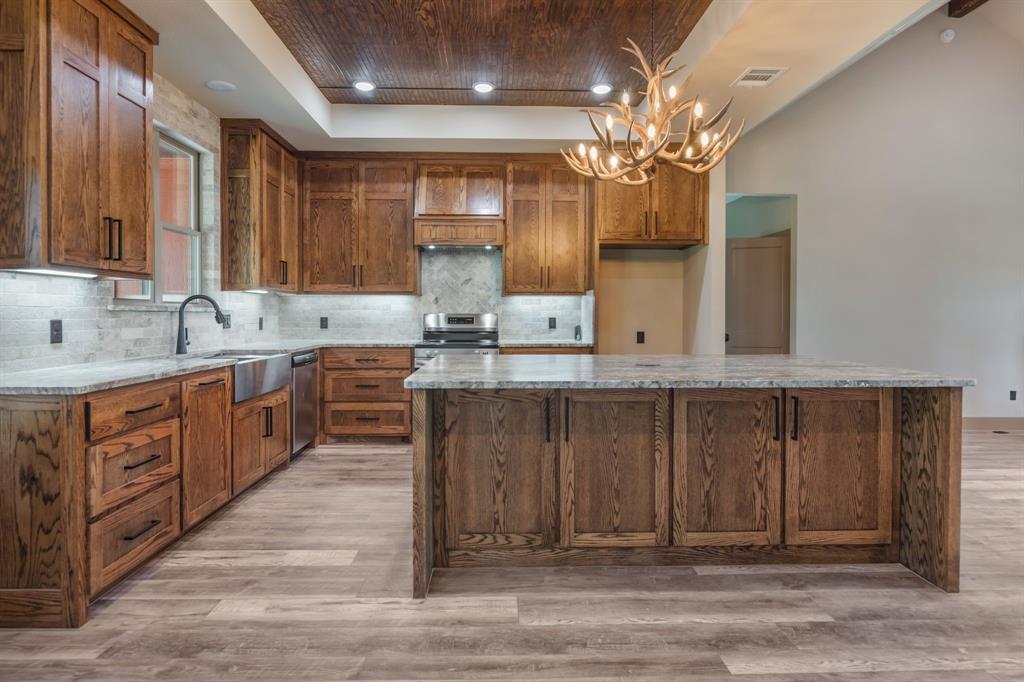 233 Jayden Lane Loving, TX 76460 - Photo 4 of 40 a kitchen with a sink and cabinets