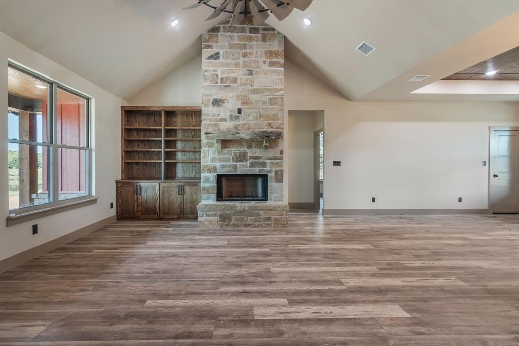 233 Jayden Lane Loving, TX 76460 - Photo 6 of 40 a view of an empty room with a fireplace and a window