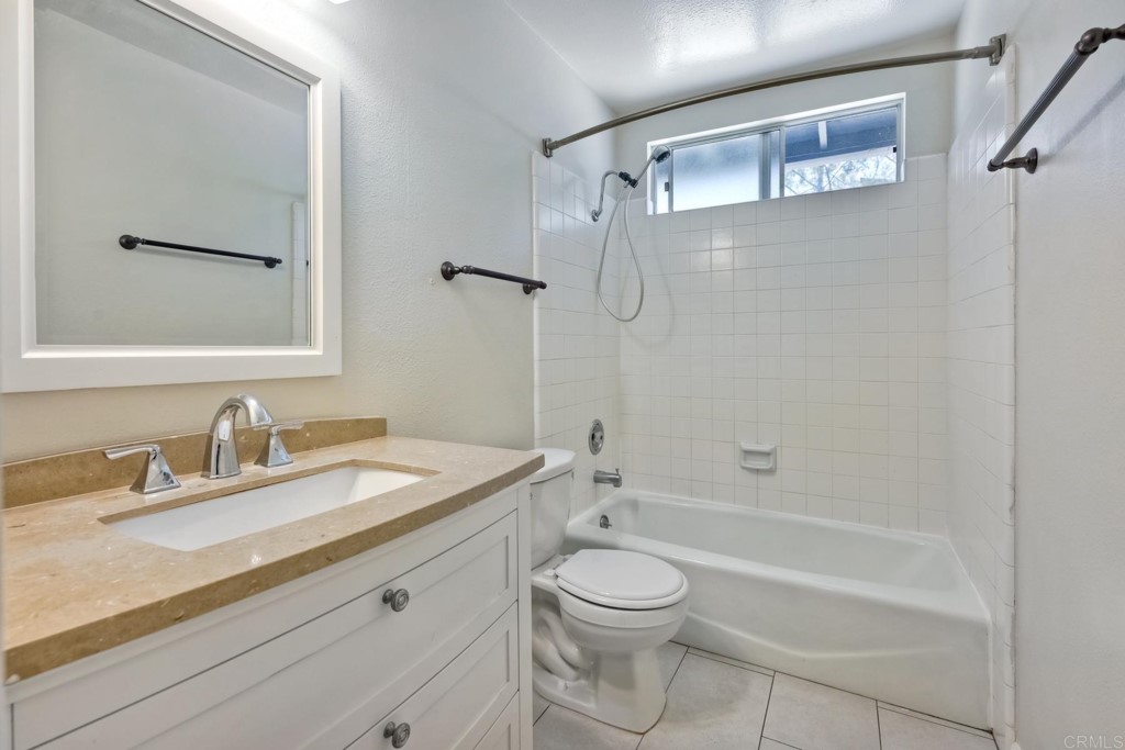 2425-27 Torrejon Place Carlsbad, CA 92009 - Photo 17 of 61 a bathroom with a granite countertop sink a toilet and shower