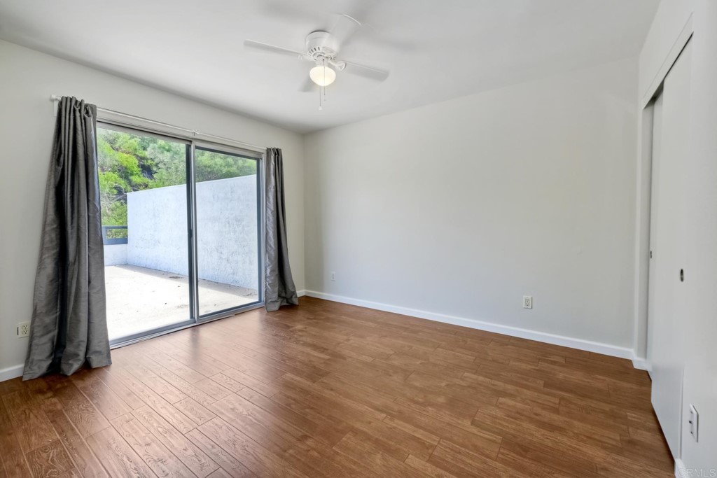 2425-27 Torrejon Place Carlsbad, CA 92009 - Photo 18 of 61 wooden floor in an empty room with a window