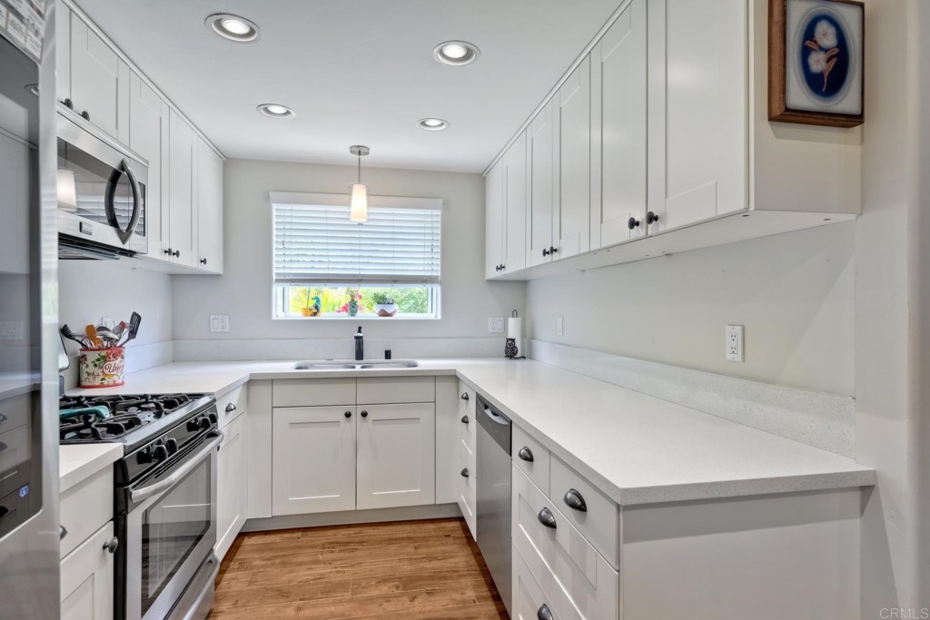 2425-27 Torrejon Place Carlsbad, CA 92009 - Photo 24 of 61 a kitchen that has a sink and a stove