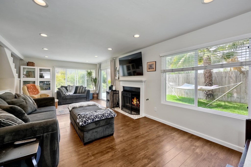 2425-27 Torrejon Place Carlsbad, CA 92009 - Photo 26 of 61 a living room with furniture a large window and a fireplace