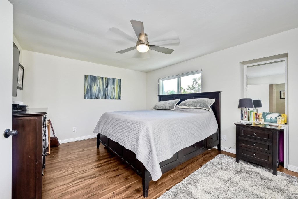2425-27 Torrejon Place Carlsbad, CA 92009 - Photo 34 of 61 a bedroom with a bed and wooden floor