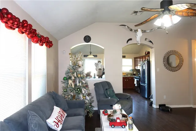 a living room with furniture and a chandelier