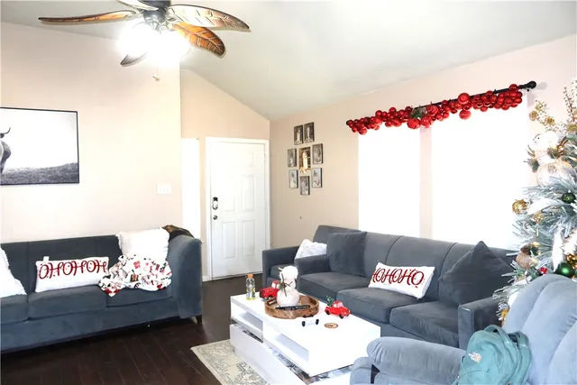a living room with furniture and flowers