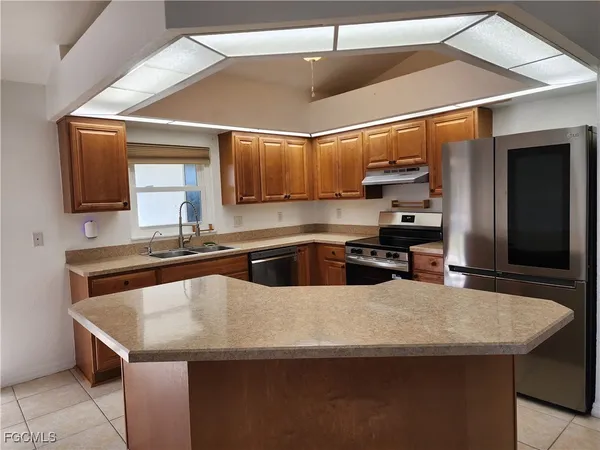 a kitchen with stainless steel appliances a sink and a refrigerator