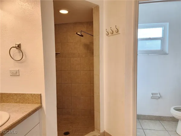 a bathroom with a granite countertop shower