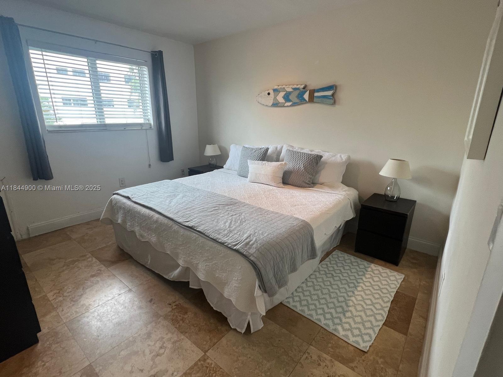 100 Sunrise Drive, Unit 27 Key Biscayne, FL 33149 - Photo 12 of 24 a bedroom with a bed and a couch