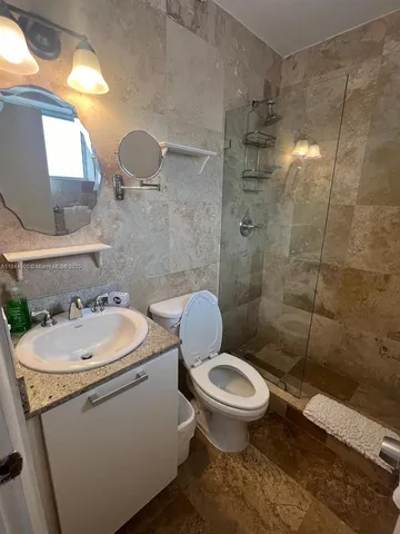 a bathroom with a sink toilet and shower