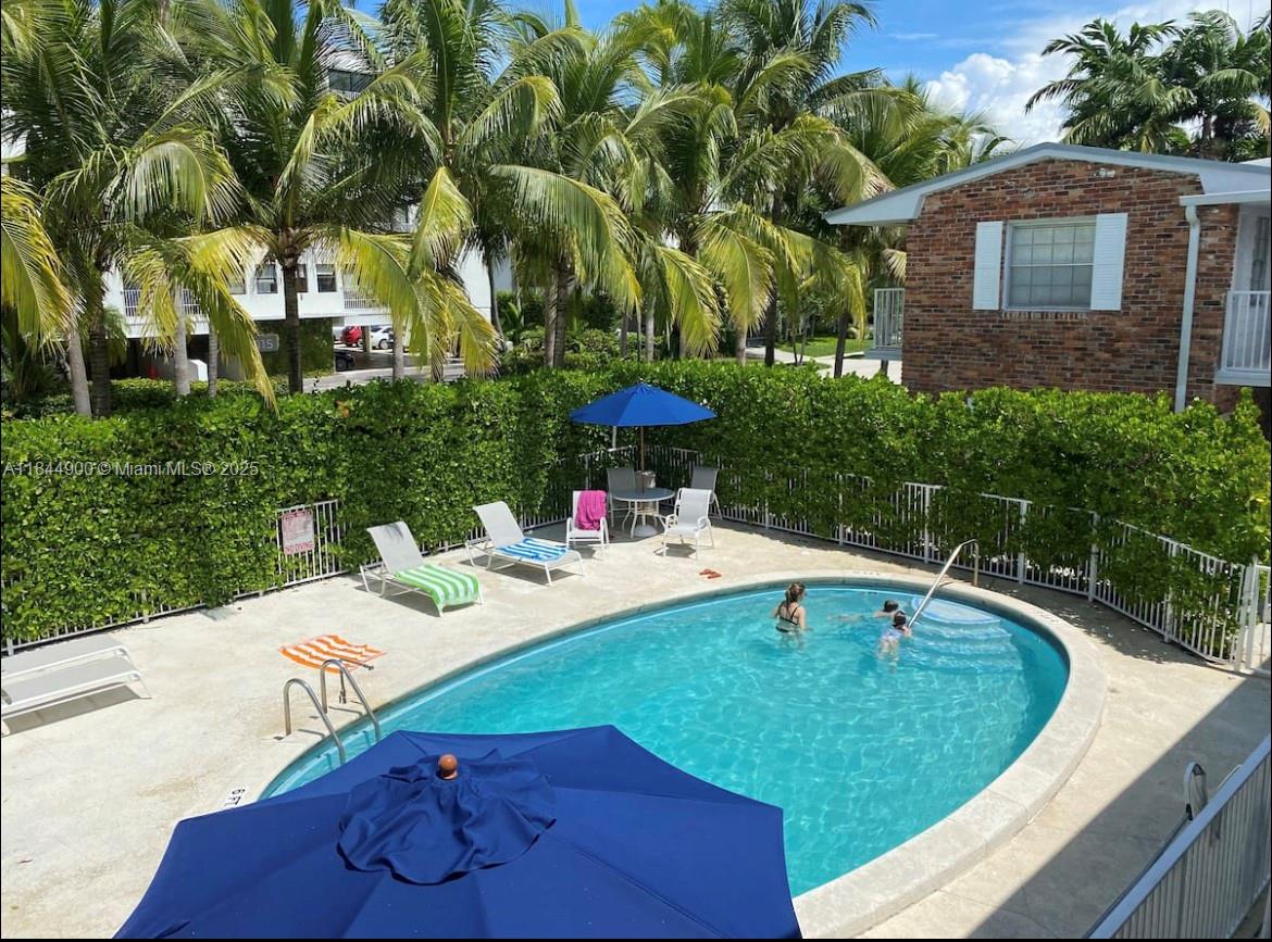 100 Sunrise Drive, Unit 27 Key Biscayne, FL 33149 - Photo 17 of 24 a view of a table and chairs in patio of the house