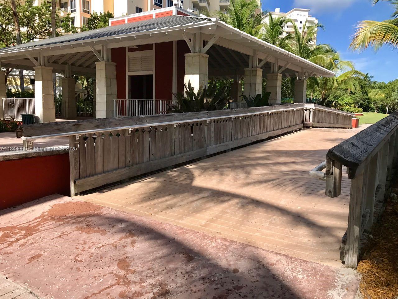 100 Sunrise Drive, Unit 27 Key Biscayne, FL 33149 - Photo 23 of 24 a view of a house with a wooden deck