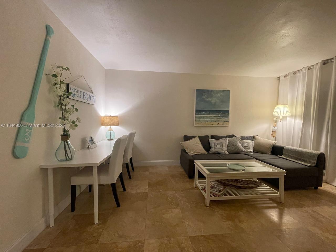 100 Sunrise Drive, Unit 27 Key Biscayne, FL 33149 - Photo 6 of 24 a living room with furniture and a window