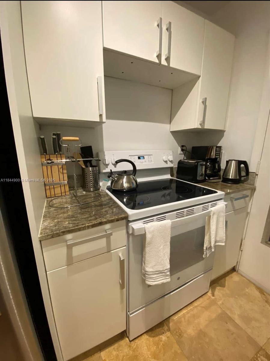 100 Sunrise Drive, Unit 27 Key Biscayne, FL 33149 - Photo 10 of 24 a kitchen with a stove and a sink