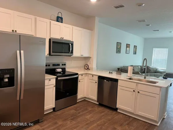 a kitchen with a sink cabinets and stainless steel appliances