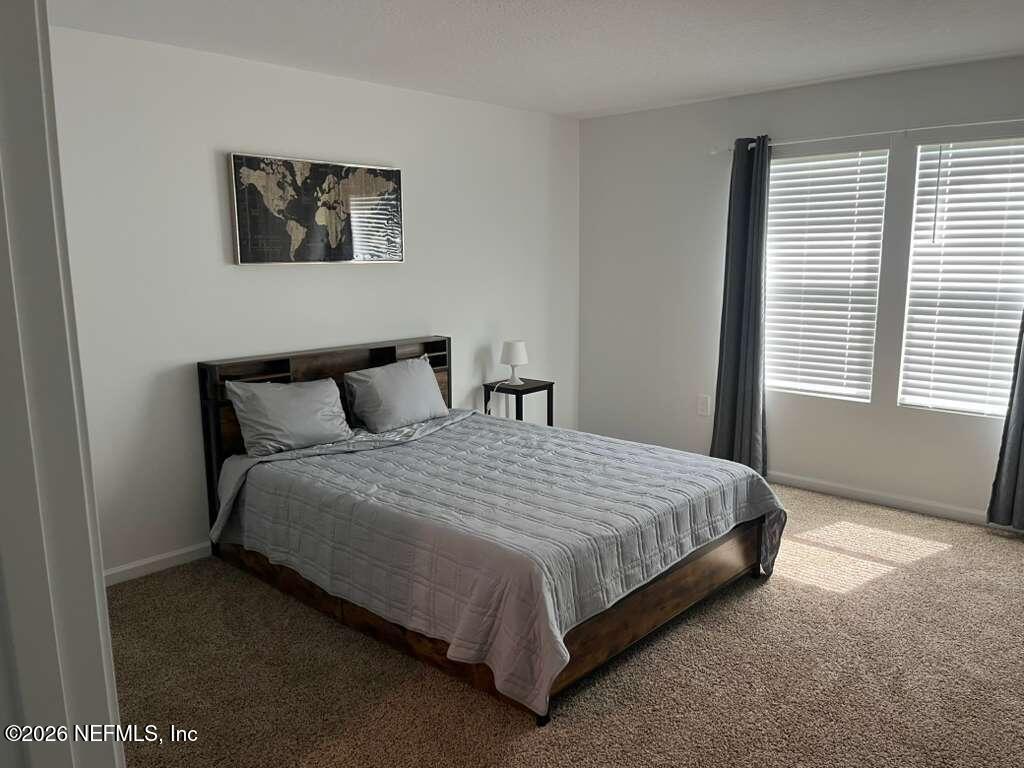 1685 Bridger Trace Middleburg, FL 32068 - Photo 8 of 13 a large bed sitting in a bedroom next to a window