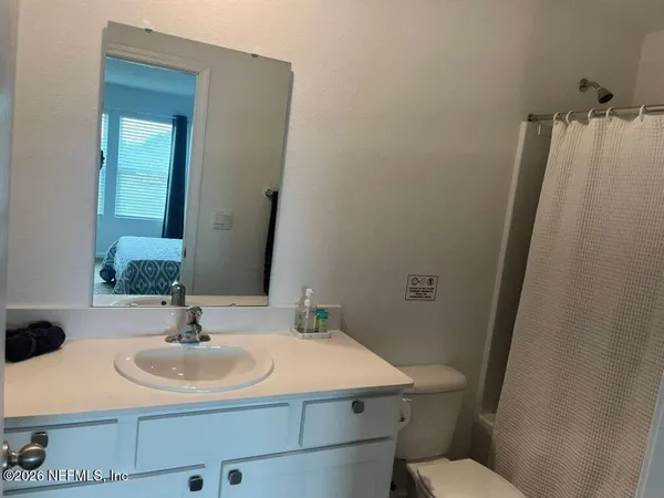 a bathroom with a sink toilet and mirror