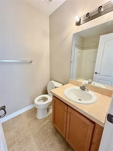 a bathroom with a sink a toilet and mirror