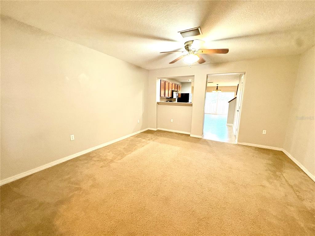 10812 Kensington Park Avenue Riverview, FL 33578 - Photo 2 of 20 a view of a big room with windows and chandelier fan