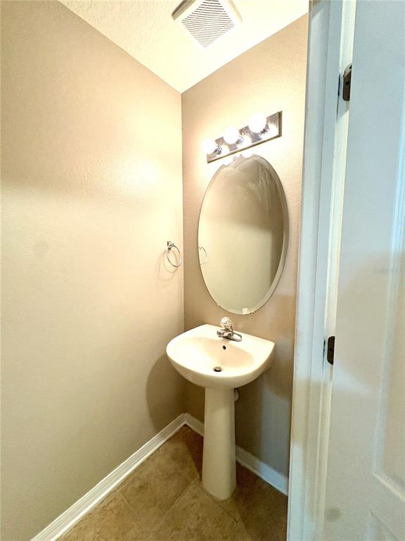 10812 Kensington Park Avenue Riverview, FL 33578 - Photo 4 of 20 a bathroom with a sink toilet and mirror
