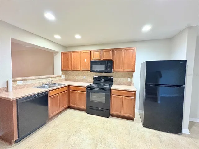 a kitchen with granite countertop stainless steel appliances and cabinets