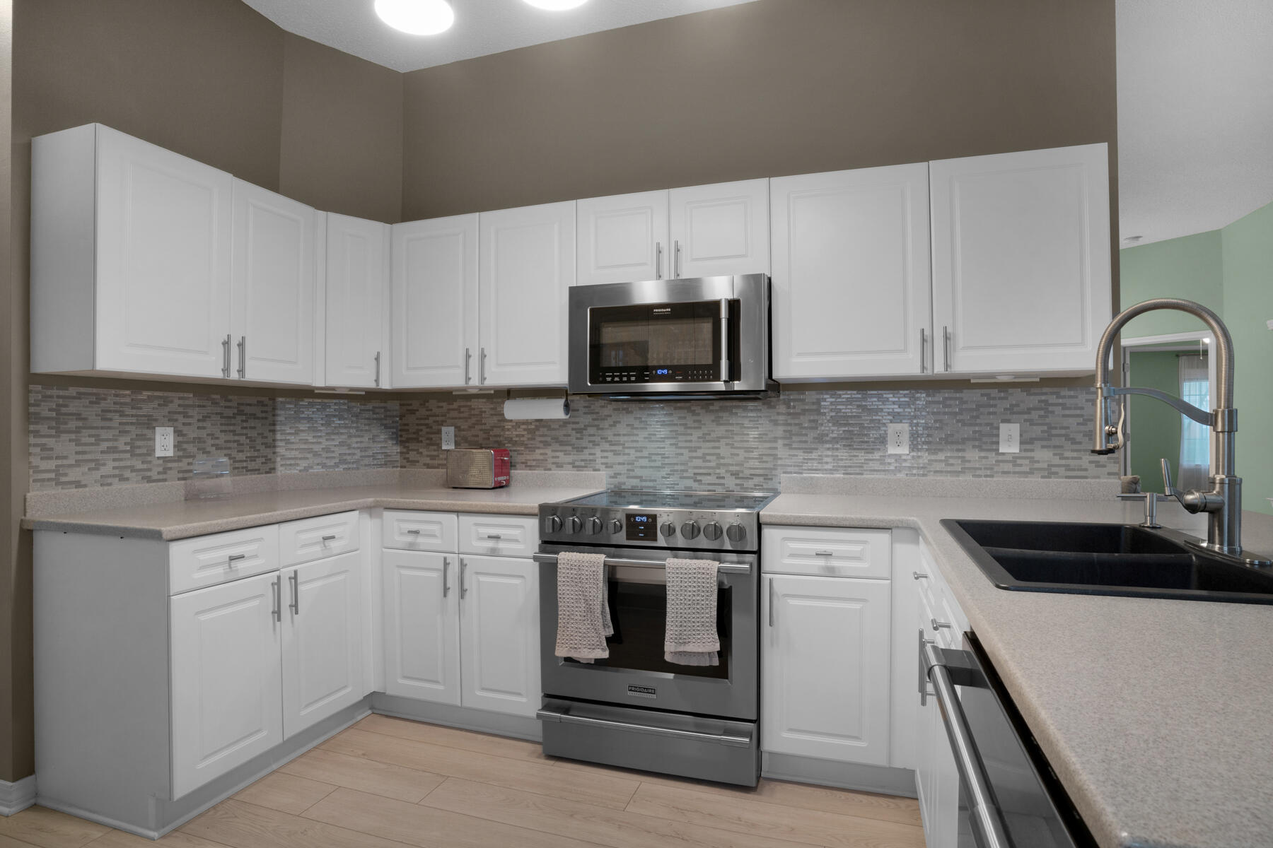 375 Bay Tree Drive Miramar Beach, FL 32550 - Photo 12 of 31 a kitchen with granite countertop white cabinets and stainless steel appliances