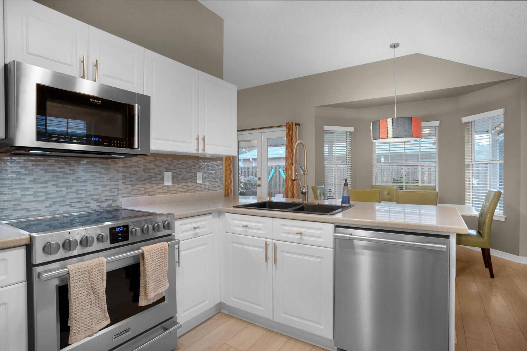 375 Bay Tree Drive Miramar Beach, FL 32550 - Photo 13 of 31 a kitchen with stainless steel appliances granite countertop a stove a sink and a microwave
