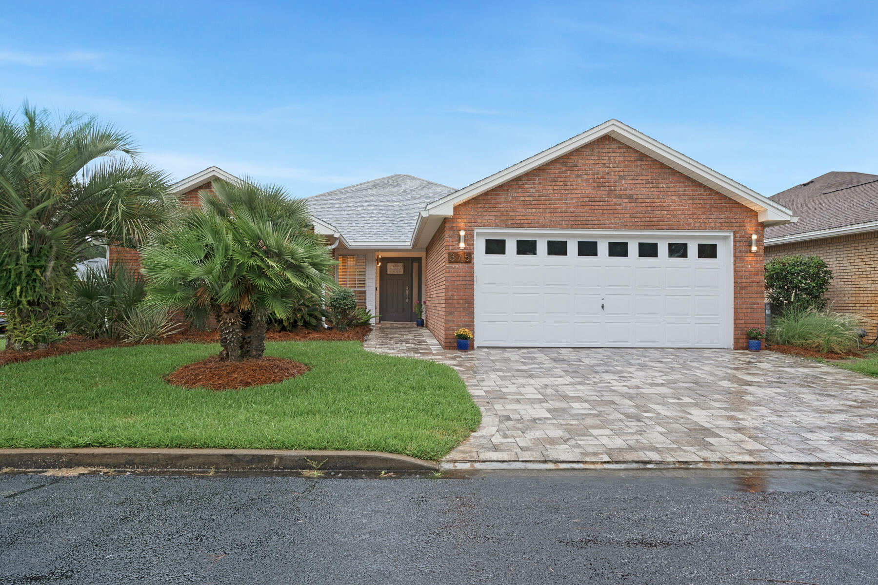 375 Bay Tree Drive Miramar Beach, FL 32550 - Photo 2 of 31 a front view of a house with a yard and garage