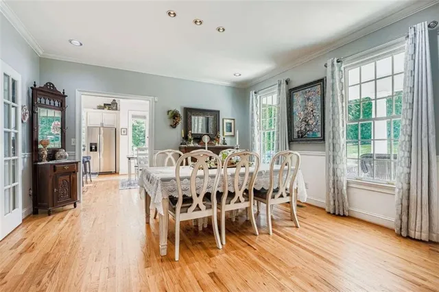 a view of a dining room with furniture window and wooden floor