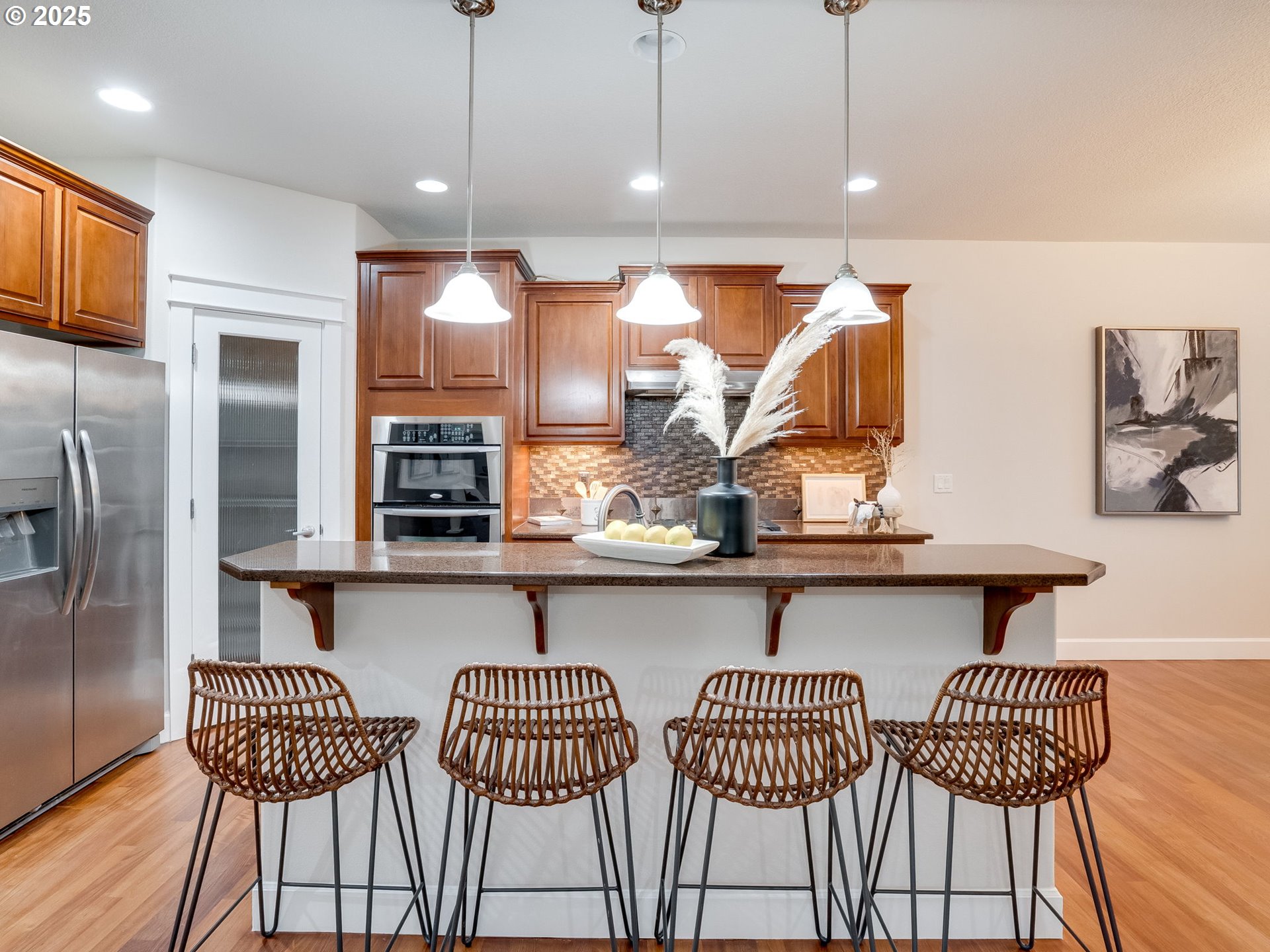 1308 Southeast 193rd Place Camas, WA 98607 - Photo 12 of 33 a kitchen with stainless steel appliances kitchen island granite countertop a table chairs and a refrigerator