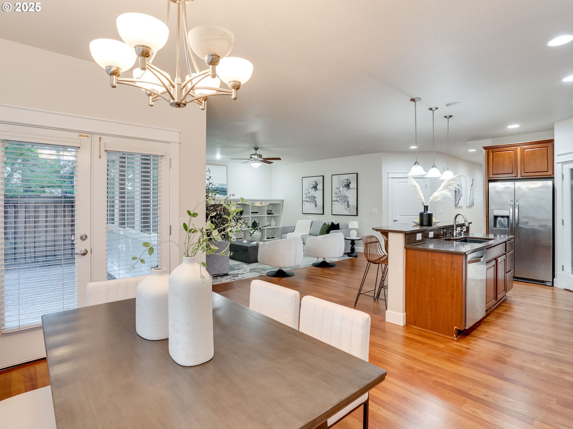 1308 Southeast 193rd Place Camas, WA 98607 - Photo 13 of 33 a dining room with wooden floor a chandelier a wooden table and chairs