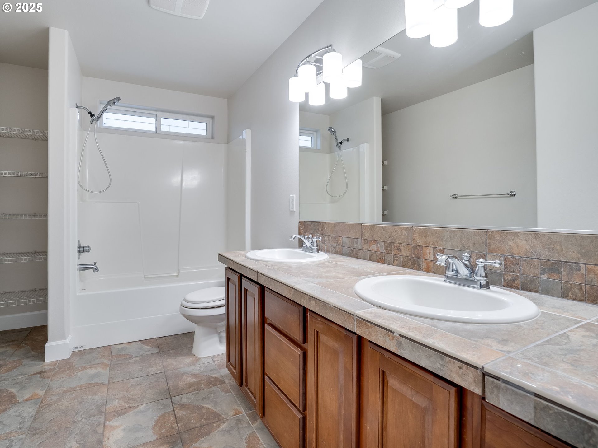 1308 Southeast 193rd Place Camas, WA 98607 - Photo 29 of 33 a bathroom with a granite countertop sink a toilet a mirror and shower