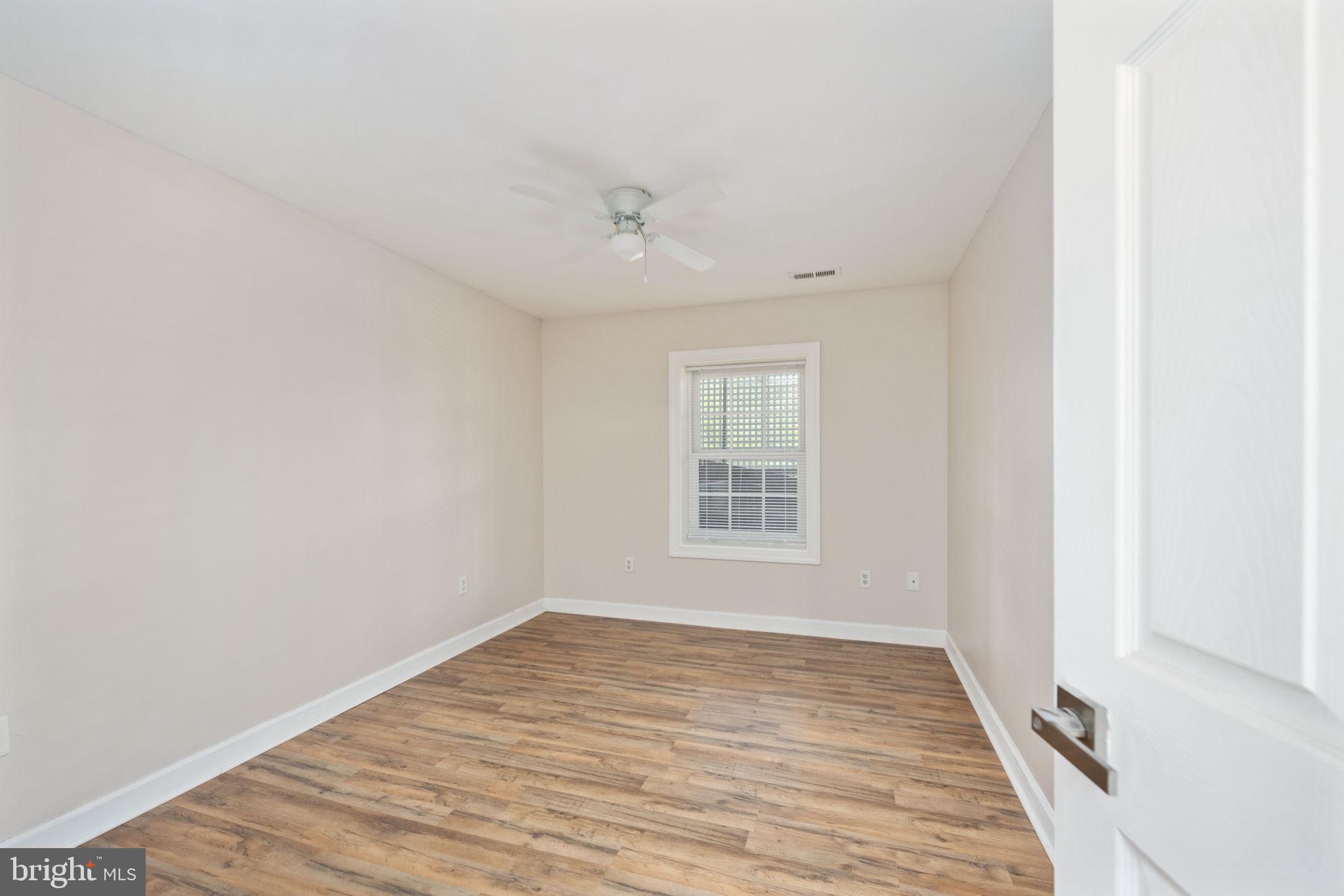 5191 Beach Ridge Lane Amissville, VA 20106 - Photo 45 of 91 an empty room with wooden floor and windows