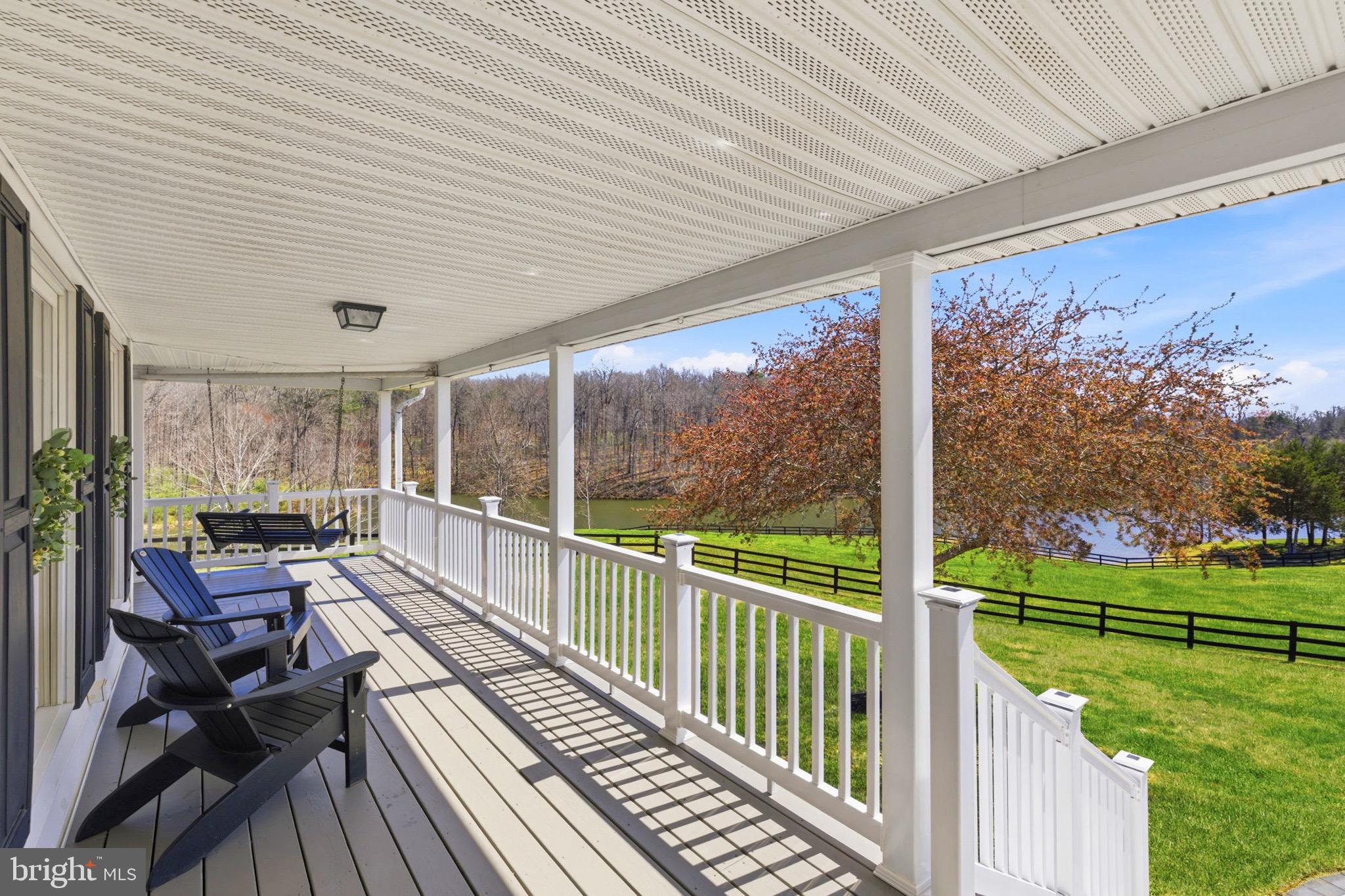 5191 Beach Ridge Lane Amissville, VA 20106 - Photo 62 of 91 a balcony with wooden floor table and chairs