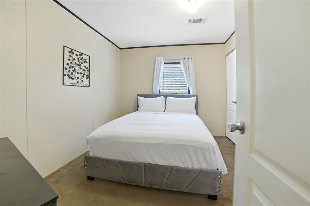 127 Almond Road Minden, LA 71055 - Photo 18 of 25 a bedroom with a bed and a window