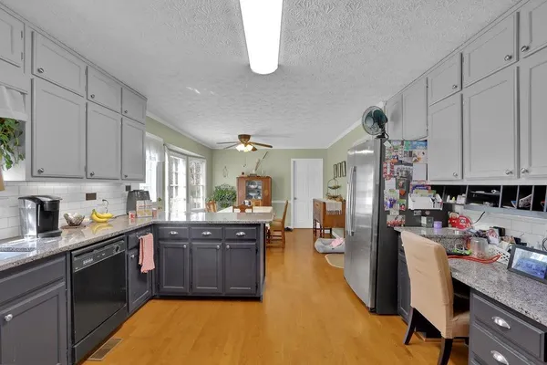 a kitchen with sink cabinets and dining table