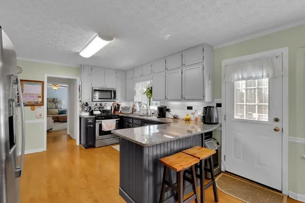 a kitchen with refrigerator and cabinets