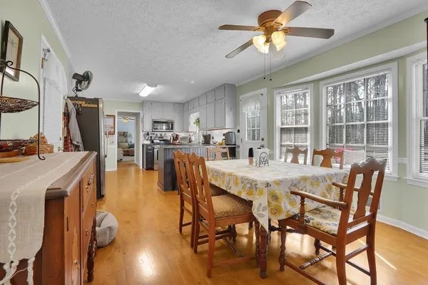 a view of a dining room with furniture window and wooden floor